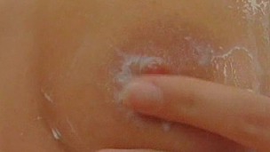 Teeb babe covered her bod with white liquid for easier masturbation